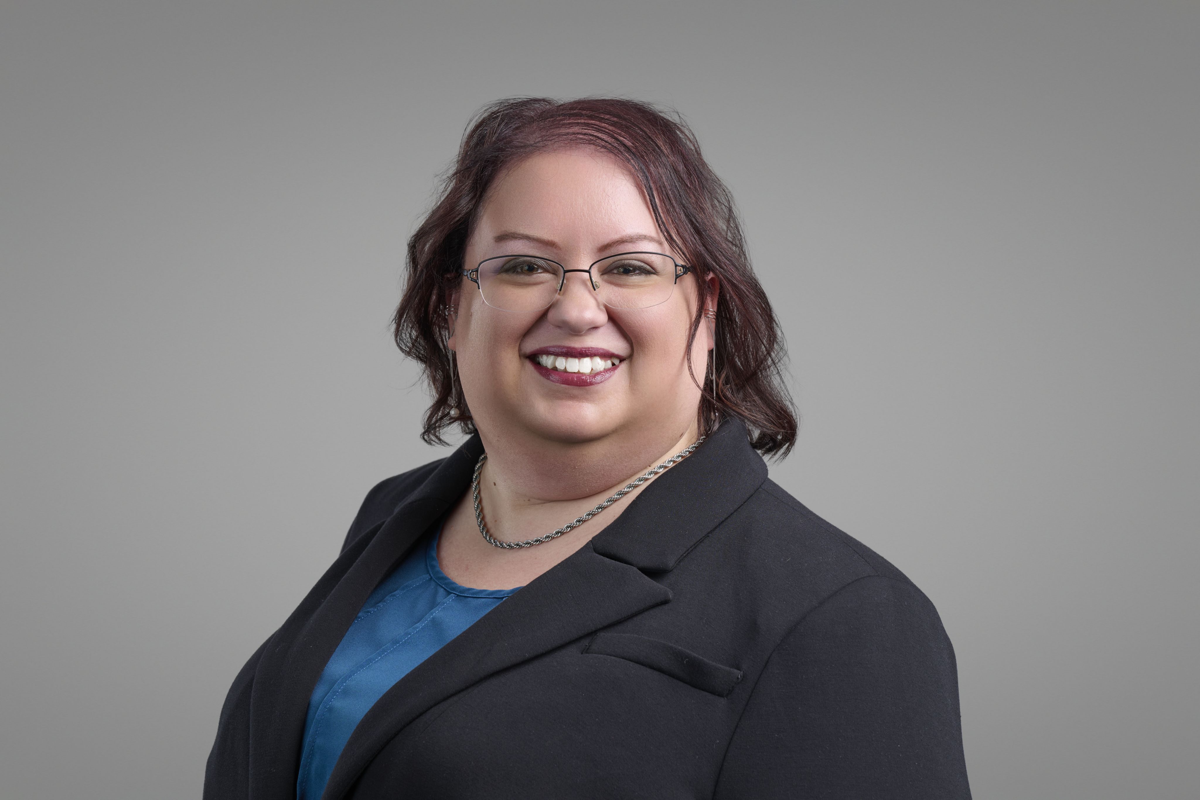 Graduates in caps and gowns toss hats in the air.