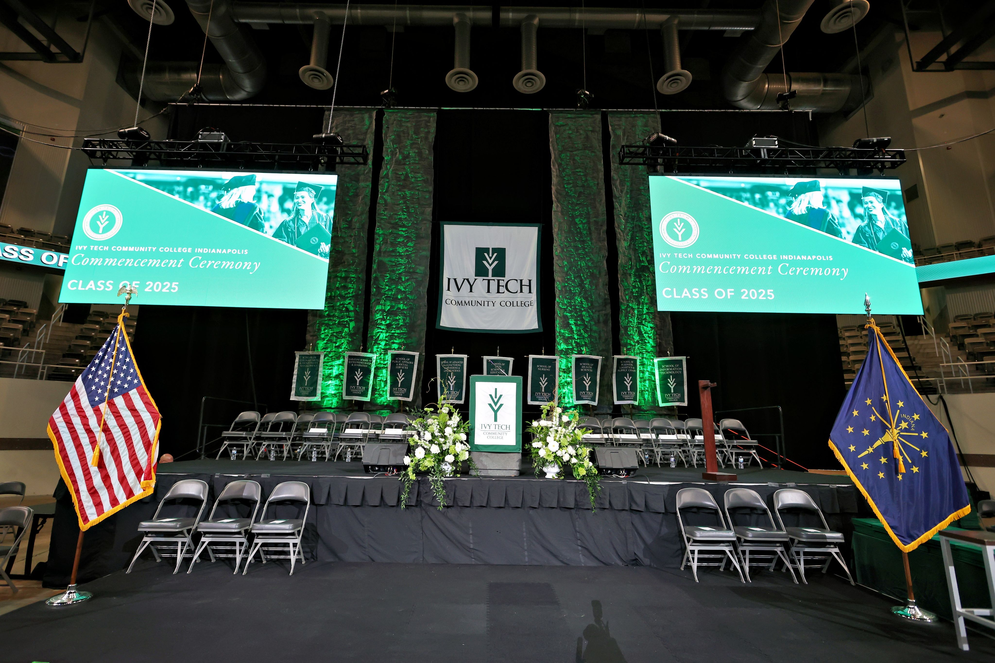 Two women arranging name badges at a registration desk during a corporate event.