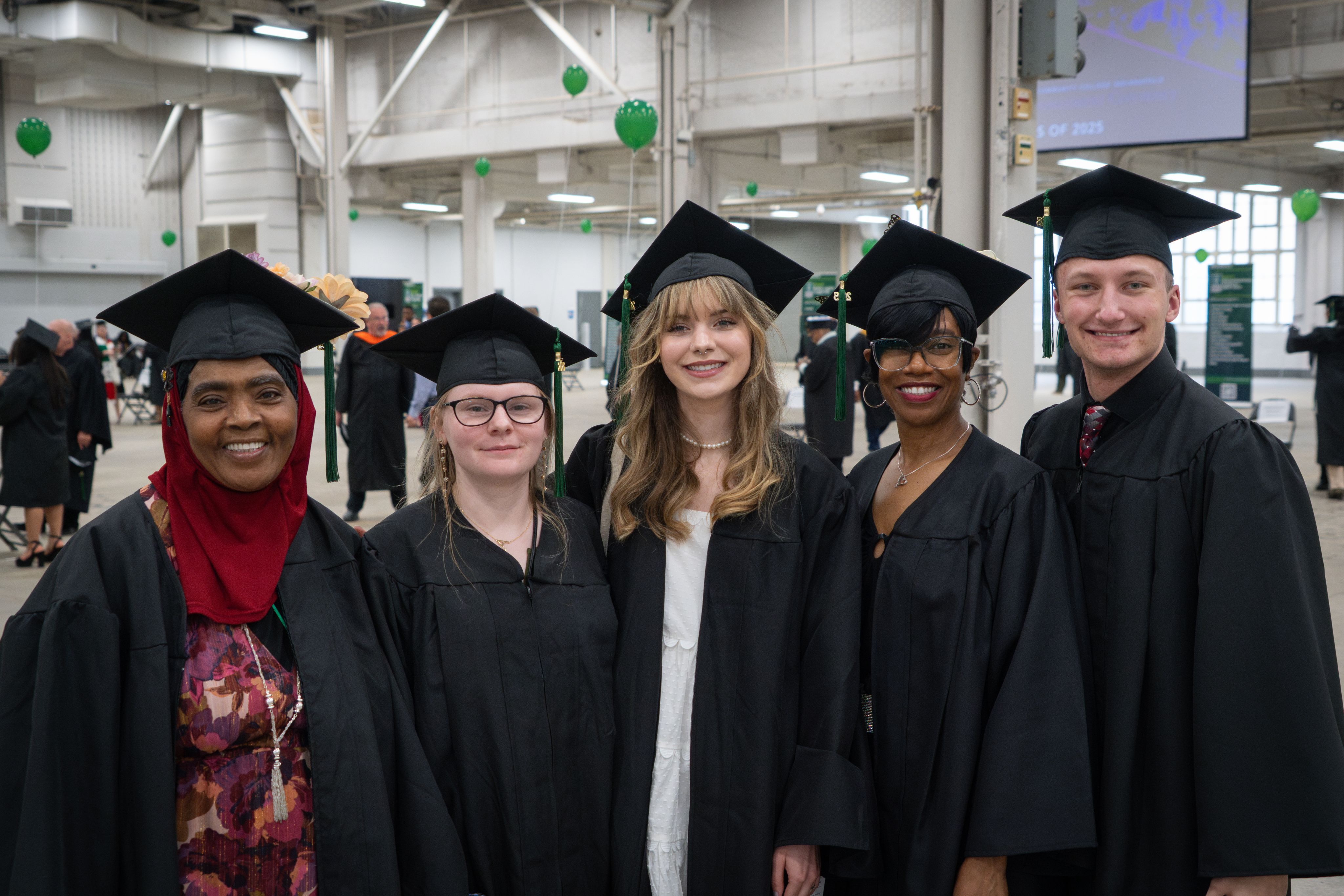 Diverse graduates in caps and gowns during a joyous graduation ceremony, celebrating achievement and success.